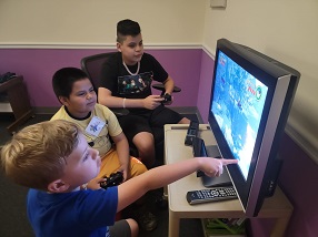boys play on computer at technology camp